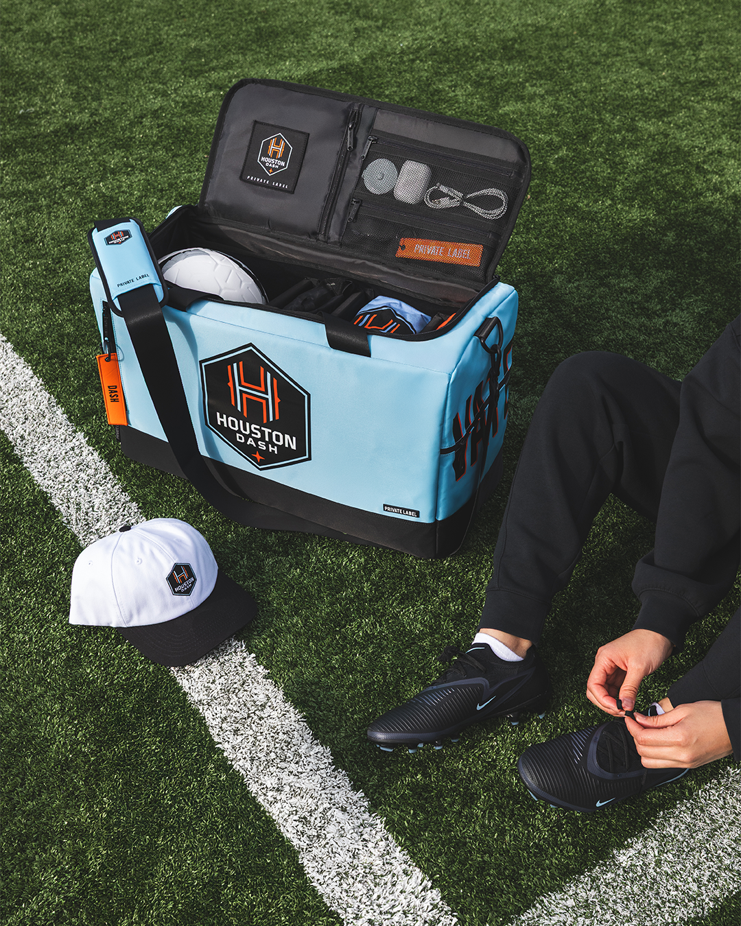 Custom Houston Dash Duffle with model on soccer field