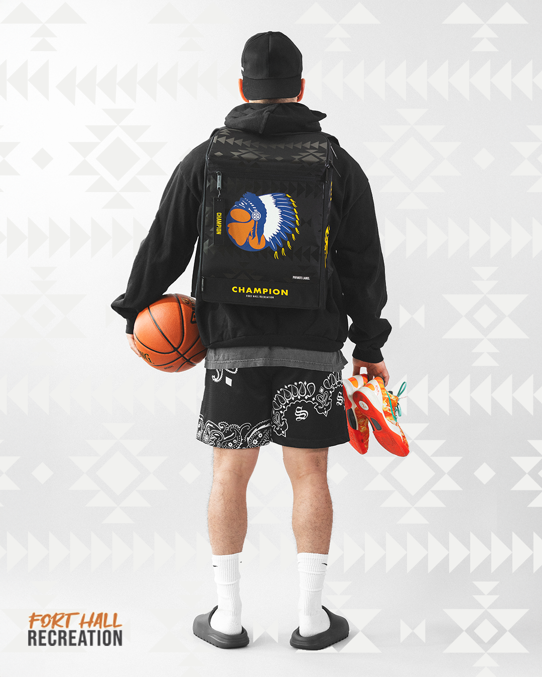 Athlete wearing a Fort Hall Recreation Backpack & holding basketball gear
