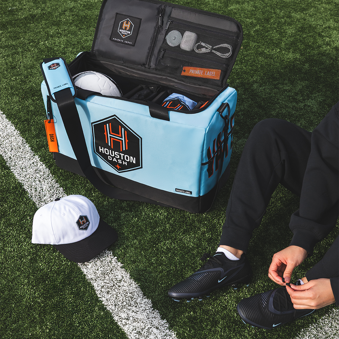 Custom Houston Dash Duffle with model on soccer field