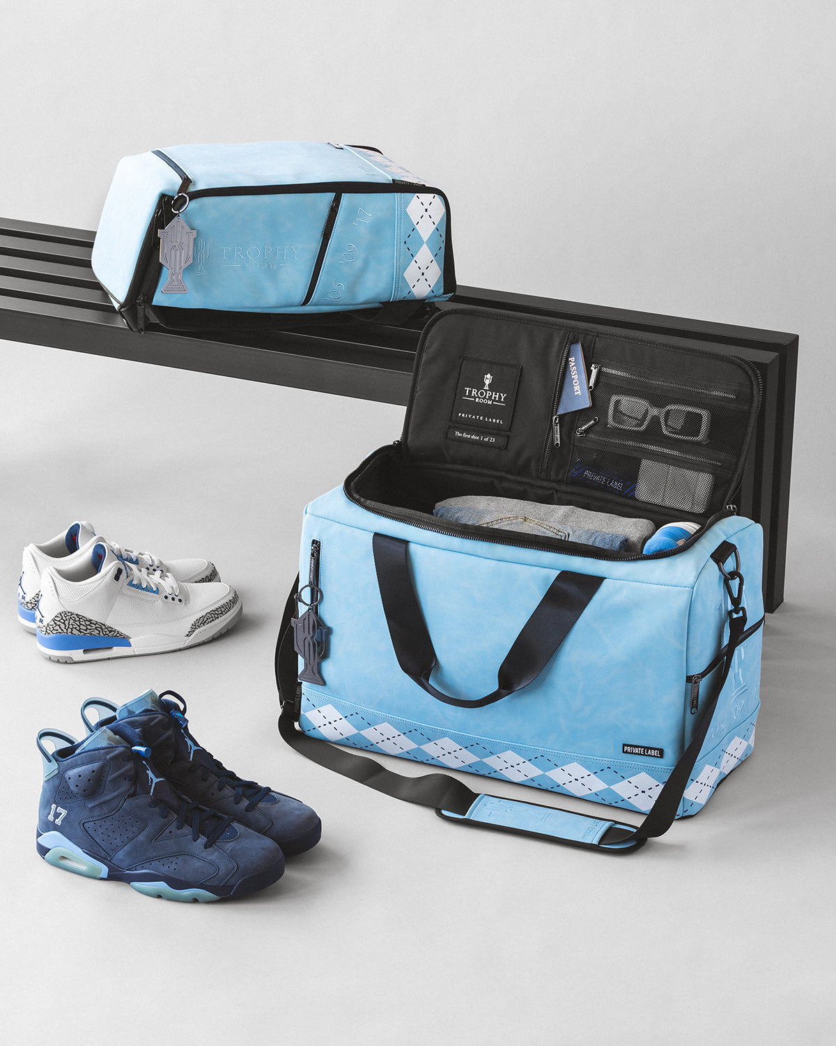 Trophy Room UNC blue duffle bag and backpack alongside jordan sneakers