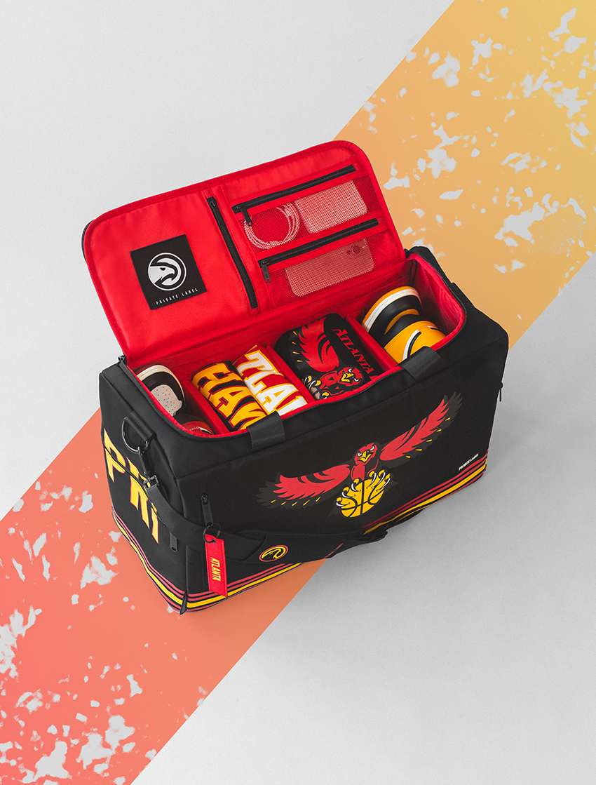 Black and red sports bag with visible branding on a colorful background