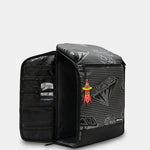 A black and gray patterned gear organizer backpack shown open, displaying its interior compartments and a small red and yellow rocket-shaped patch on the front.