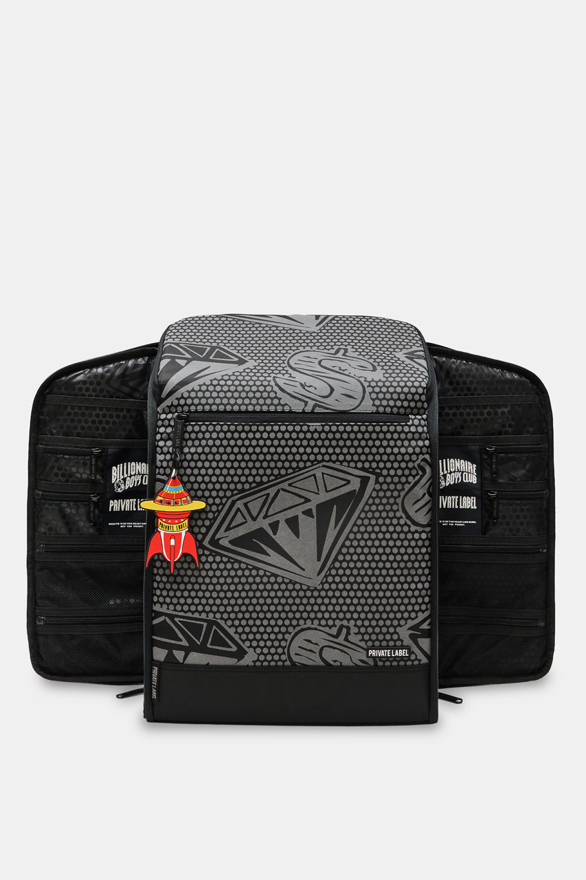 A black and gray patterned backpack shown from the front, with a matching black zippered pouch placed behind it on a light gray background. The front bag has a gray geometric diamond pattern on a black base, and the pouch behind it is solid black with side pockets and a small red-and-yellow hanging tag.