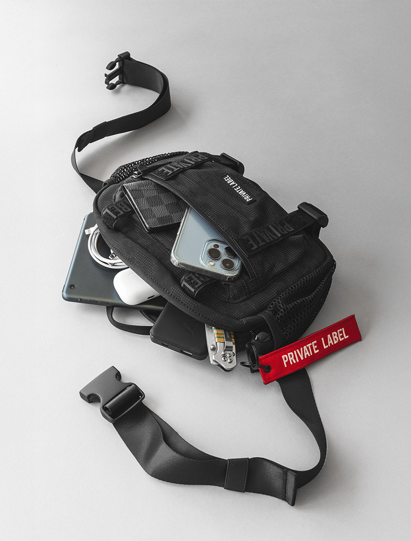 Black waist bag with a phone case on a white background