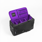 A black and purple travel organizer bag shown open, featuring a purple interior with multiple zippered pockets and organizer compartments, photographed on a clean white background.