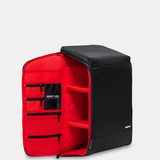 Black and red backpack with open front compartment on a light gray background