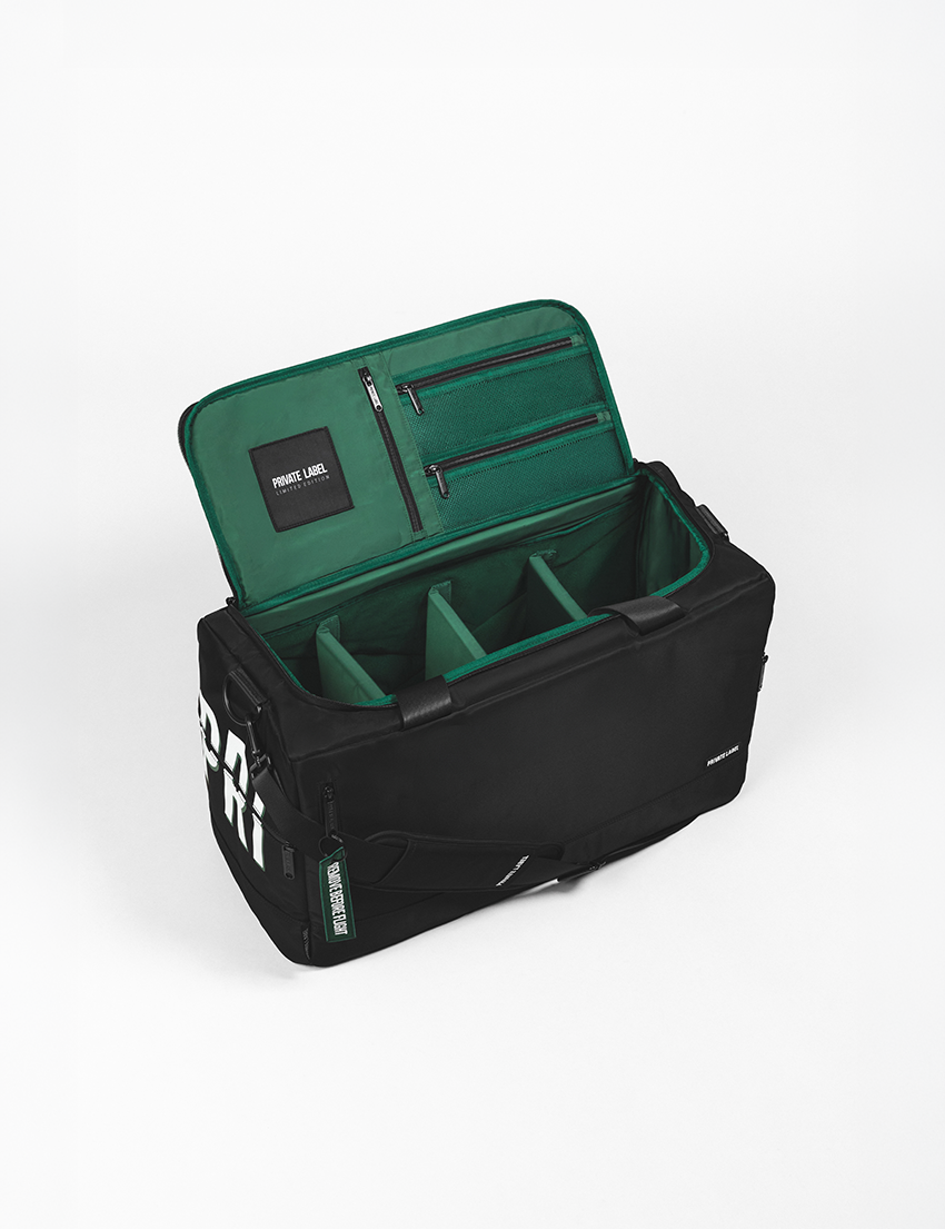 Black duffle with a green interior on a light grey background
