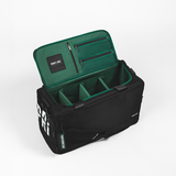 Black duffle with a green interior on a light grey background