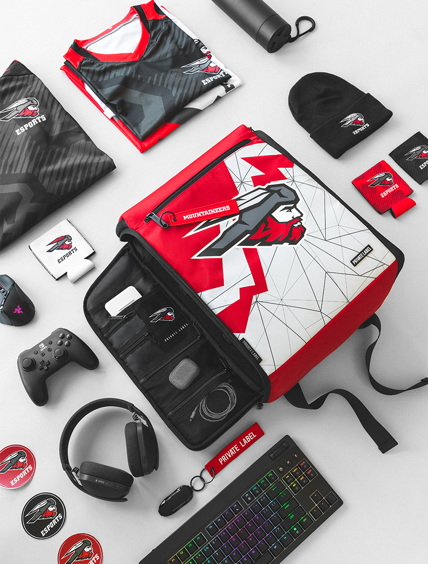 A flat-lay product display of a red, black, and Mountaineers themed gear set, including a laptop organizer bag, athletic jersey, headset, keyboard, controller, and various branded accessories on a white background.