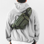 Model wearing cap & hoodie with Green Sling bag on back