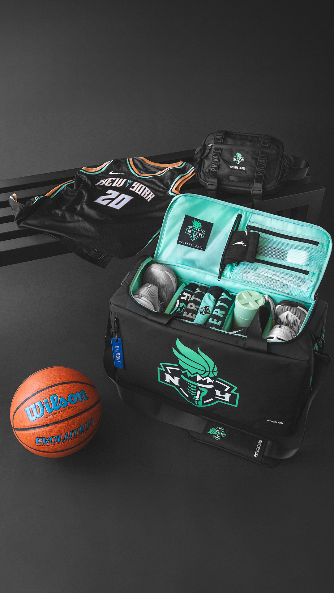 Basketball and sports bag with branded items on a dark surface