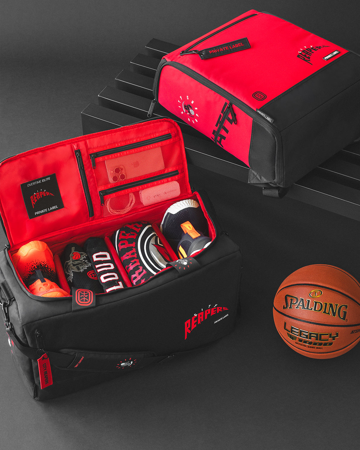 Black & red duffle with a red backpack to match. Basketball accessories packed inside the duffle alongside a basketball