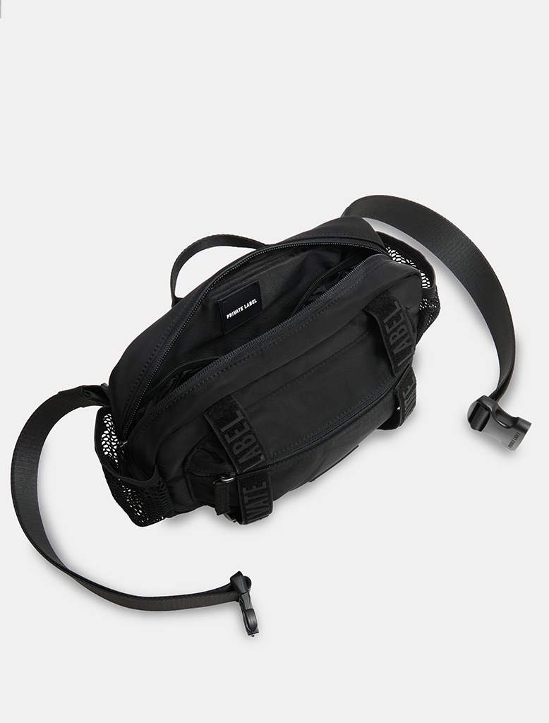 Black waist bag with a strap on a light gray background