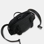Black waist bag with a strap on a light gray background