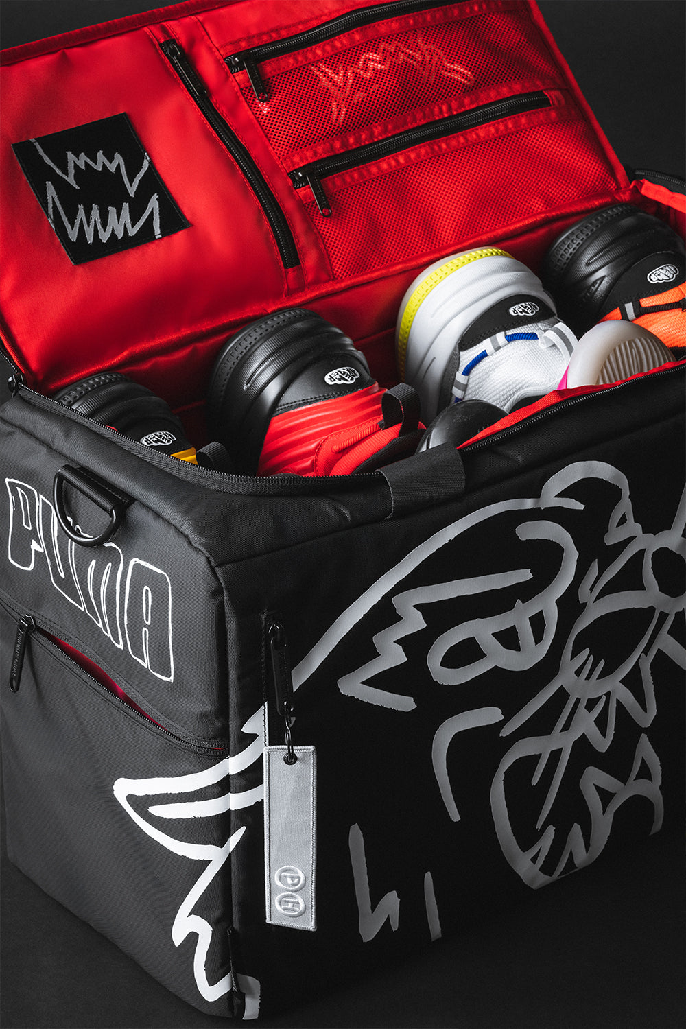 Black and red sports bag with shoes inside on a dark background