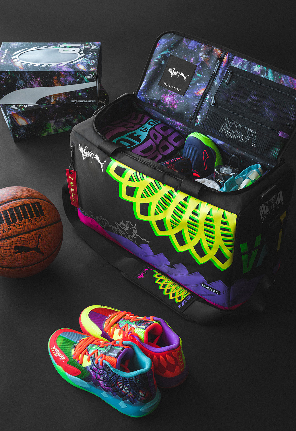 Colorful duffle with a galaxy printed interior featuring MELO's puma collaboration duffle alongside his signature shoes and a puma basketball