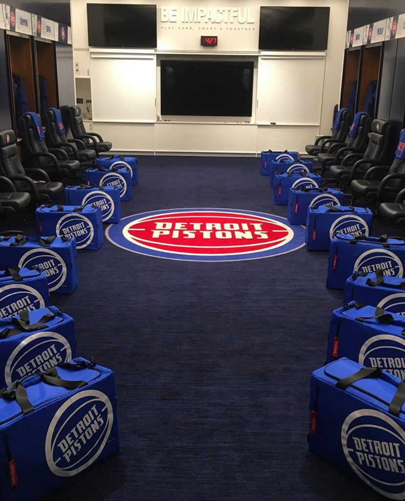 Multiple Blue Pistons Duffle bags set up in their locker room