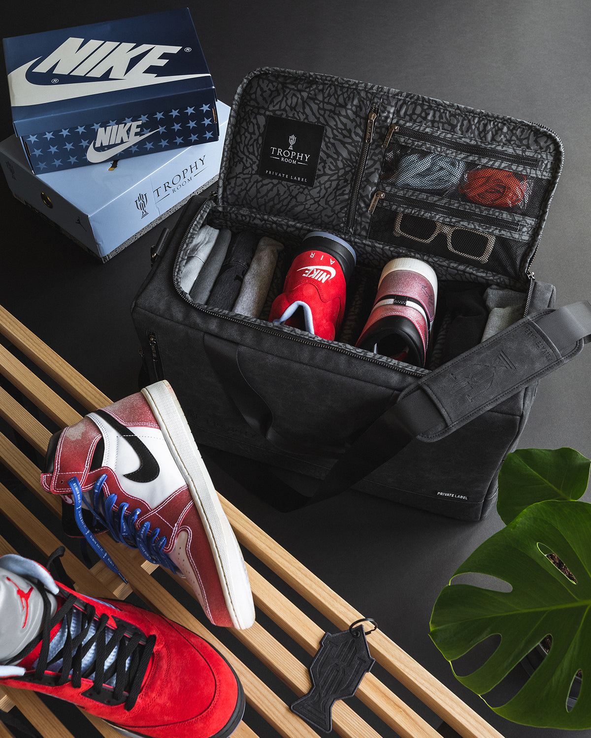 Trophy Room x Private Label Duffle bag with Nike shoes on the bench